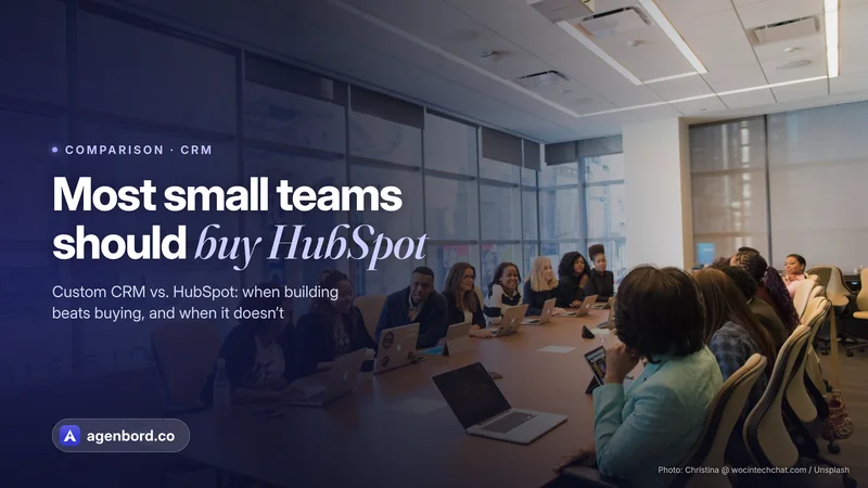 A team meeting around a long table with laptops. Headline: Most small teams should buy HubSpot
