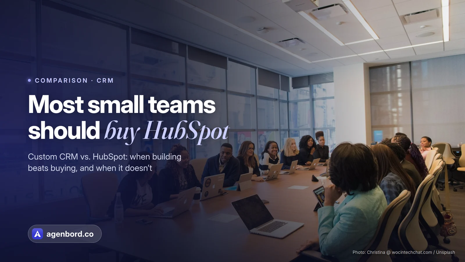 A team meeting around a long table with laptops. Headline: Most small teams should buy HubSpot