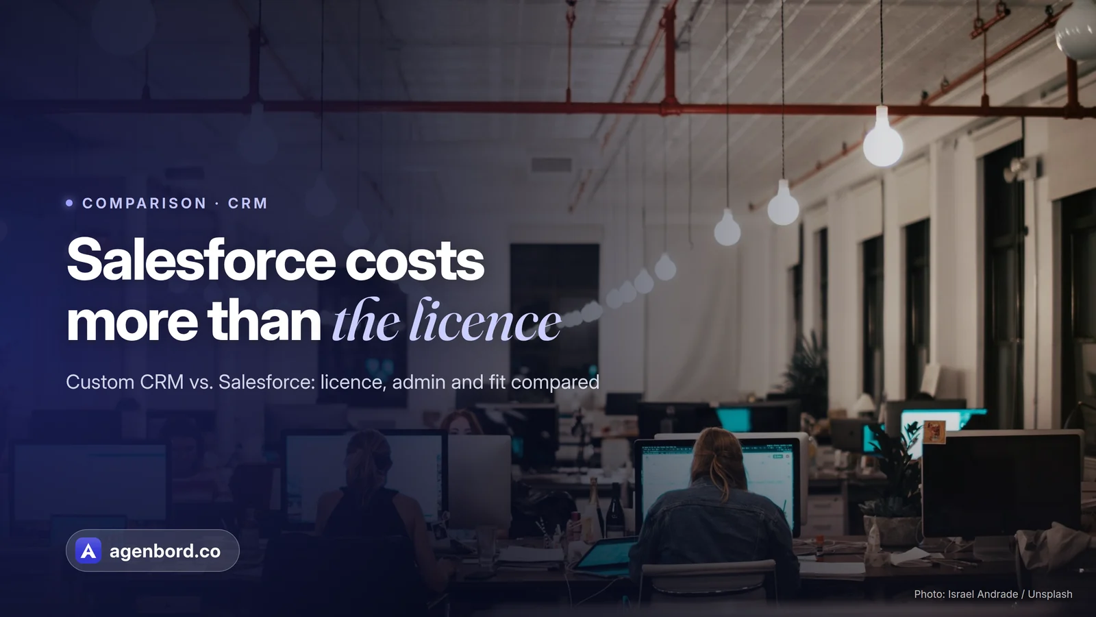 A busy open-plan office with people working at computers. Headline: Salesforce costs more than the license